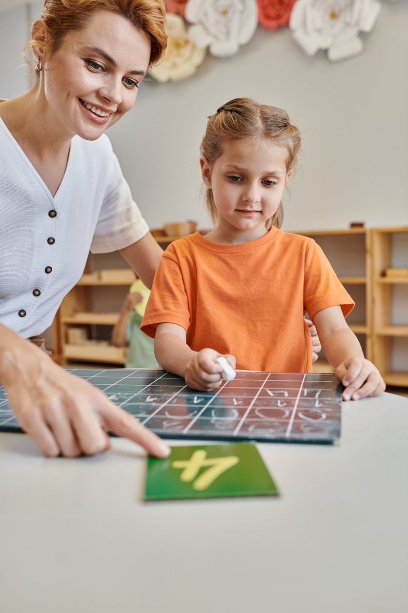 Engaging teacher guides a girl in hands-on learning at Montessori classroom